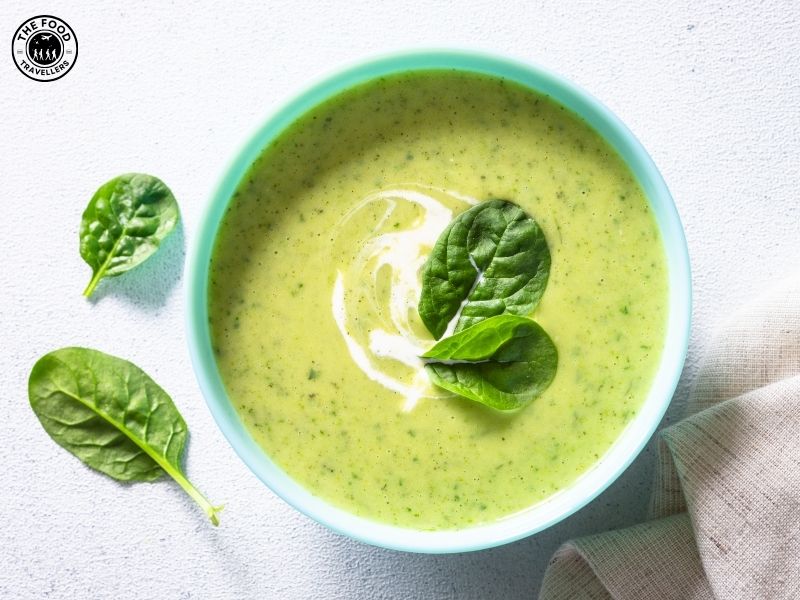 Delicious bowl of creamy Cheesy Zucchini Soup, garnished with herbs, showcasing a smooth, comforting texture.