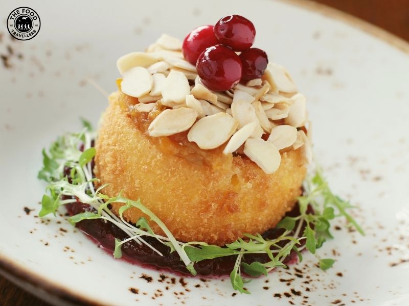 Golden-brown Cranberry Brie Knots: Flaky pastry twisted with creamy Brie and sweet-tart cranberries, ideal for festive occasions.