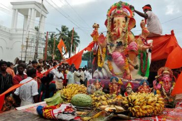A beautifully decorated idol of Lord Ganesha with flowers and lights during Ganesh Chaturthi celebrations.