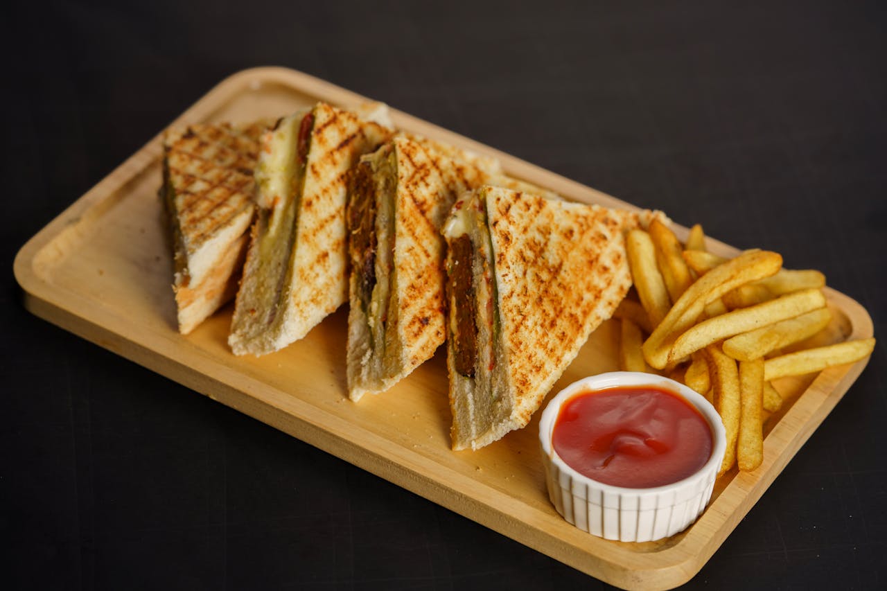 A golden-brown grilled cheese sandwich with gooey melted cheese oozing from between two crispy slices of bread.