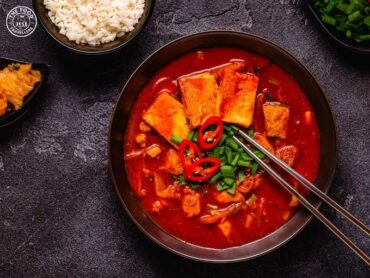 A bowl of vibrant kimchi, Korea's iconic fermented dish, showcasing its rich colors and textures.