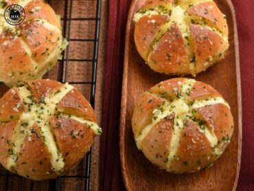 Golden Korean cream cheese garlic bread, filled with rich cream cheese and coated in a savory garlic butter glaze.