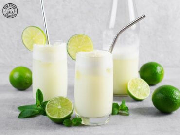 Glass of Lusty Lime Virgin Mocktail with a slice of lime and mint garnish, served in a chilled glass.