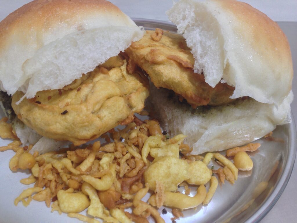 Puneri Vada Pav with a spicy potato fritter, garlic chutney, and soft pav, a flavorful twist on the classic Mumbai snack.