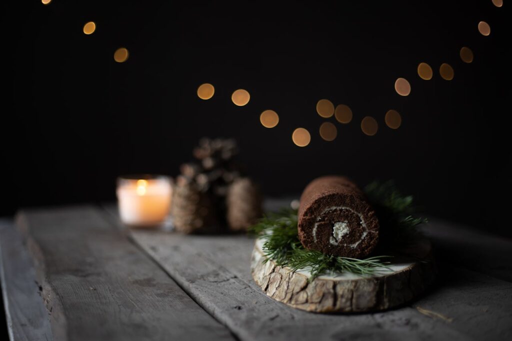 Traditional Yule Log cake decorated with chocolate frosting and festive accents, ready for the holiday celebration.