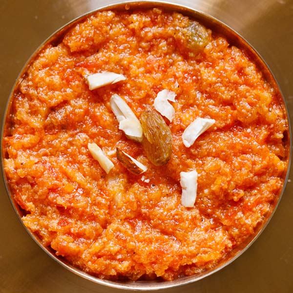 Close-up of gajar ka halwa, a traditional Indian dessert made with grated carrots, milk, sugar, and ghee, topped with chopped nuts.
