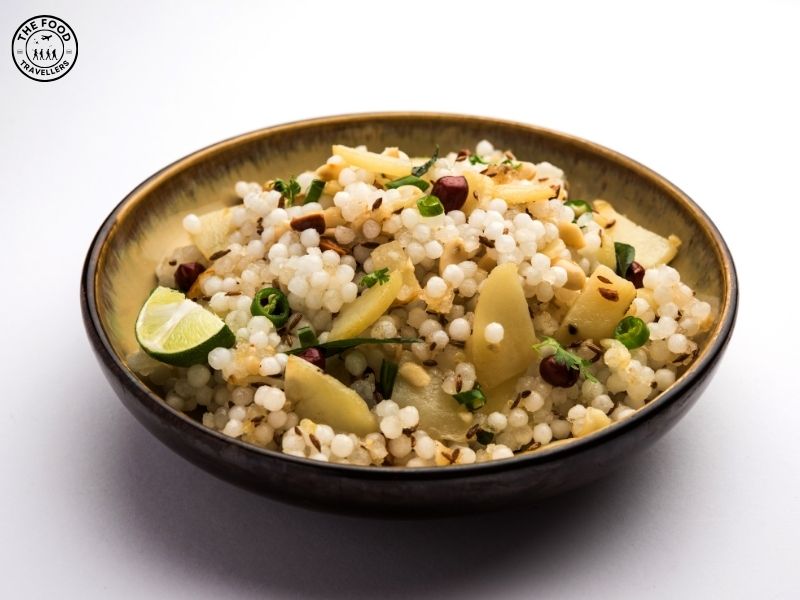 A plate of Sabudana Khichdi, garnished with fresh cilantro, featuring tapioca pearls, potatoes, and spices, served as a savory, flavorful dish.