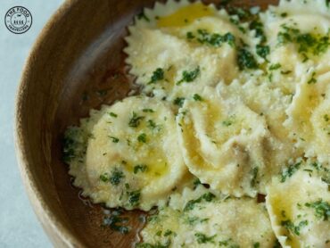 Delicious spinach ravioli served in a rich, golden burnt butter sauce, garnished with fresh herbs and grated parmesan.