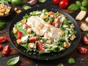 A fresh Veg Caesar Salad featuring crisp lettuce, creamy dressing, crunchy croutons, and a sprinkle of parmesan cheese.