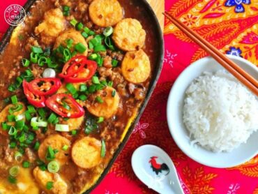 A sizzling Veg Hot Pot served on a hot plate, featuring a colorful mix of vegetables cooked in aromatic spices, with steam rising and a vibrant, appetizing look.