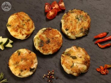 "Golden-brown Vegan Bubble and Squeak patties made from potatoes and mixed vegetables, served on a plate.