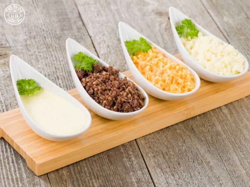 A serving of Vegan Haggis, made with plant-based ingredients like lentils, oats, and spices, served on a plate with traditional sides.