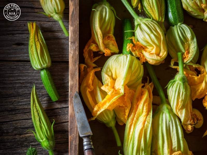 Fresh zucchini flowers with vibrant yellow petals, ready to be stuffed or cooked.