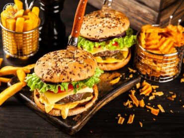 Delicious vegan burger with a plant-based patty, fresh vegetables, and a vegan-friendly bun, served with crispy fries on the side.