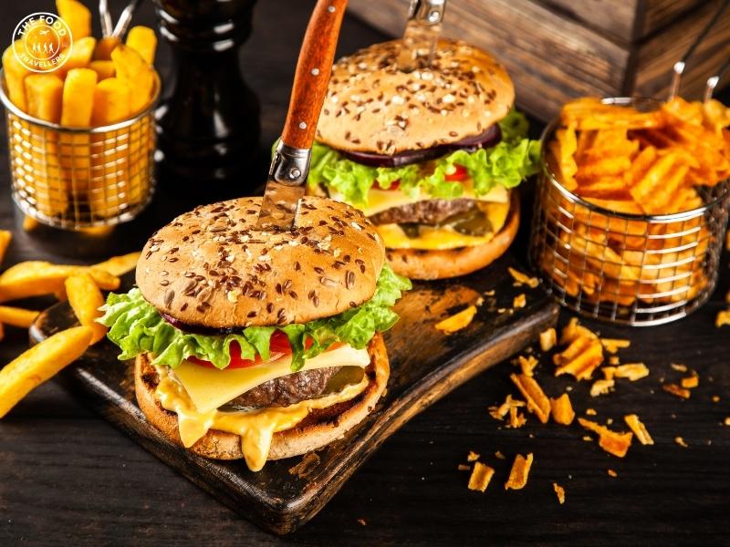 Delicious vegan burger with a plant-based patty, fresh vegetables, and a vegan-friendly bun, served with crispy fries on the side.