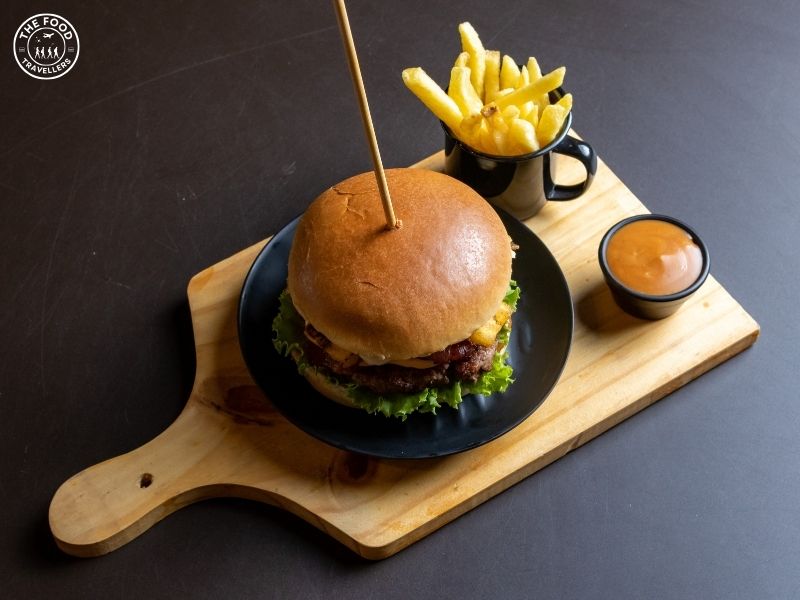 Vibrant vegan burger with a juicy plant-based patty, topped with fresh lettuce, tomato, and pickles, all nestled in a soft bun.