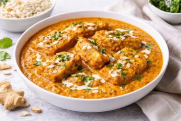 Creamy Paneer Pasanda recipe served in rich Mughlai gravy garnished with cream and coriander