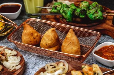 Crispy Mumbai style samosas with spicy potato filling served with mint and tamarind chutney
