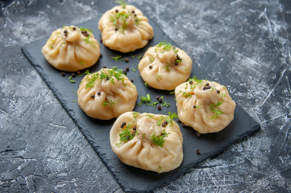Veg momos recipe featuring 15 café-style veg and vegan variations served with different dipping sauces