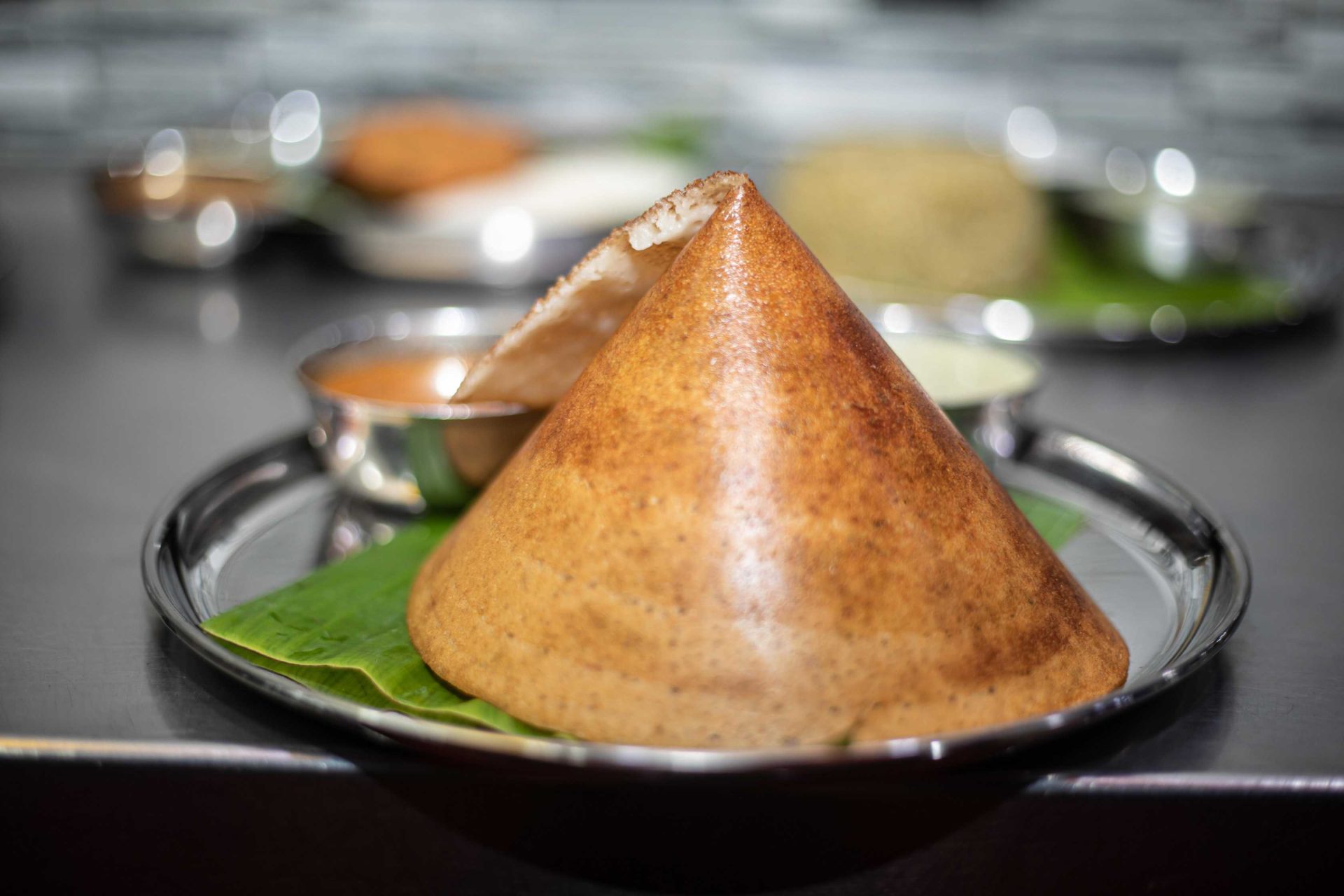 Masala dosa recipe served crispy with potato filling, coconut chutney, tomato chutney, and sambar on the side