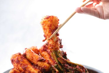 Traditional Korean kimchi served in a bowl with napa cabbage and chili paste