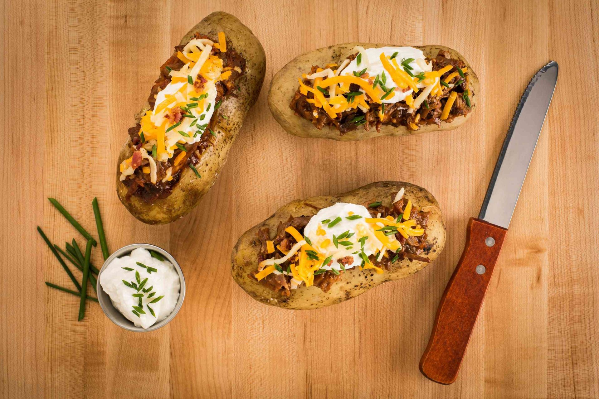 Veg baked potato with melted cheese, broccoli, corn and sour cream on crispy potato skin